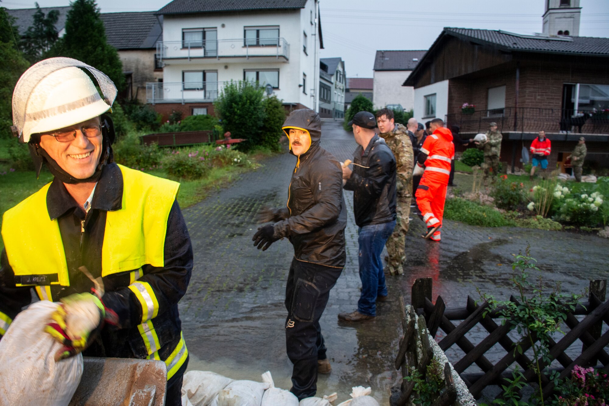 Members from the 52nd Civil Engineer Squadron from Spangdahlem Air Base, Germany, work with German first responders and community members to deliver sandbags to the town of Binsfeld, Germany, July 14, 2021.