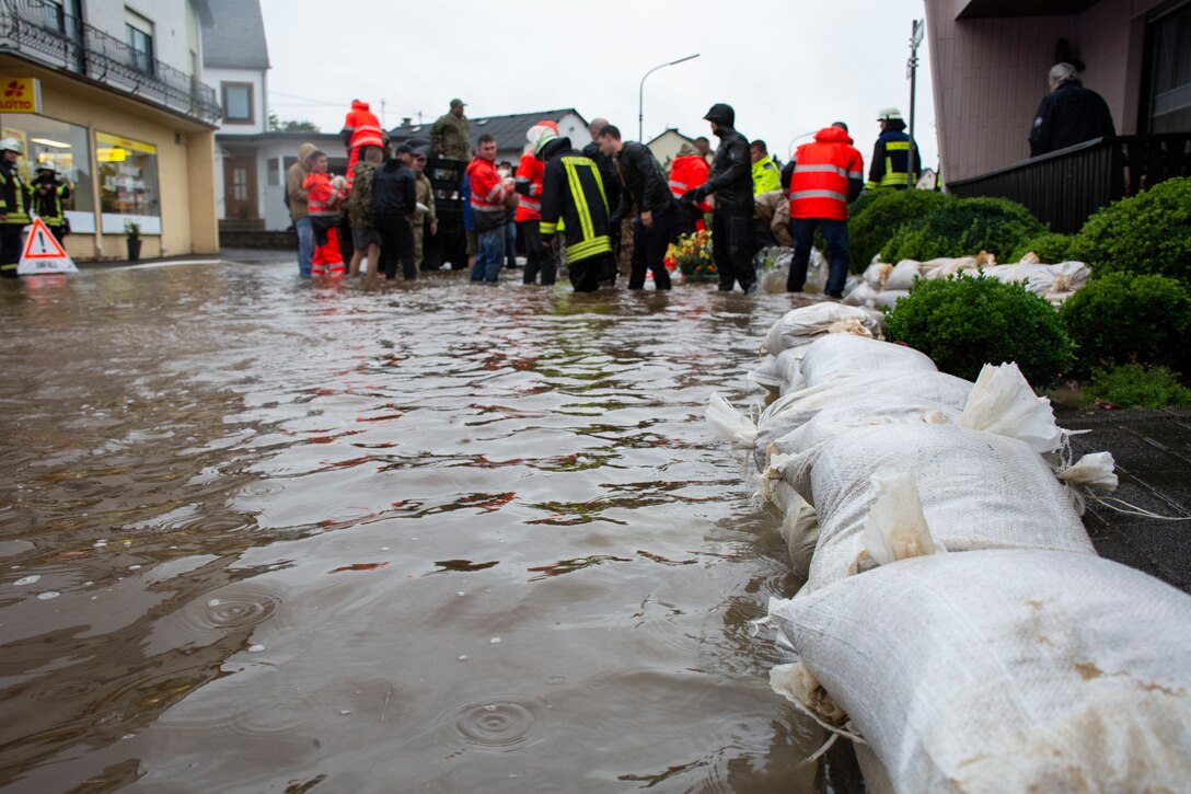 Members from the 52nd Civil Engineer Squadron from Spangdahlem Air Base, Germany, work with German first responders and community members to deliver sandbags to the town of Binsfeld, Germany, July 14, 2021.