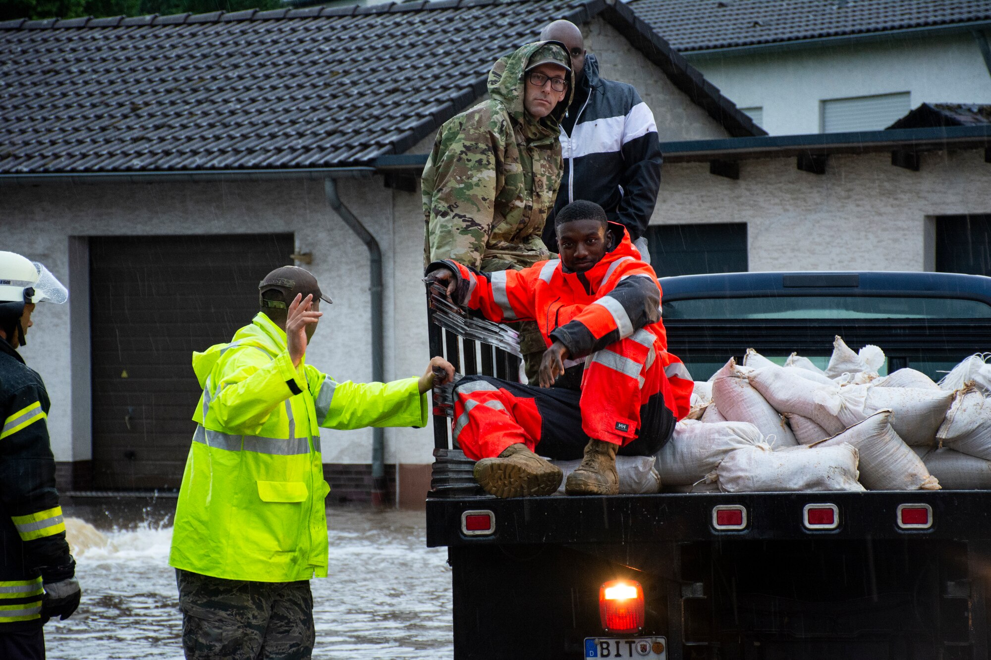 Members from the 52nd Civil Engineer Squadron from Spangdahlem Air Base, Germany, work with German first responders and community members to deliver sandbags to the town of Binsfeld, Germany, July 14, 2021.