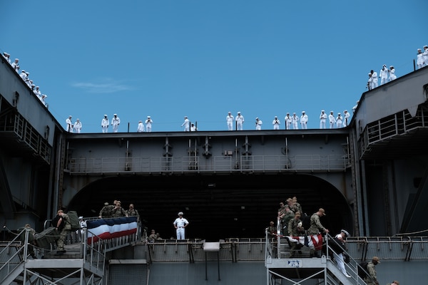 Sailors depart the Nimitz-class aircraft carrier USS Dwight D. Eisenhower (CVN 69) after the ship returned to Naval Station Norfolk, July 18.
