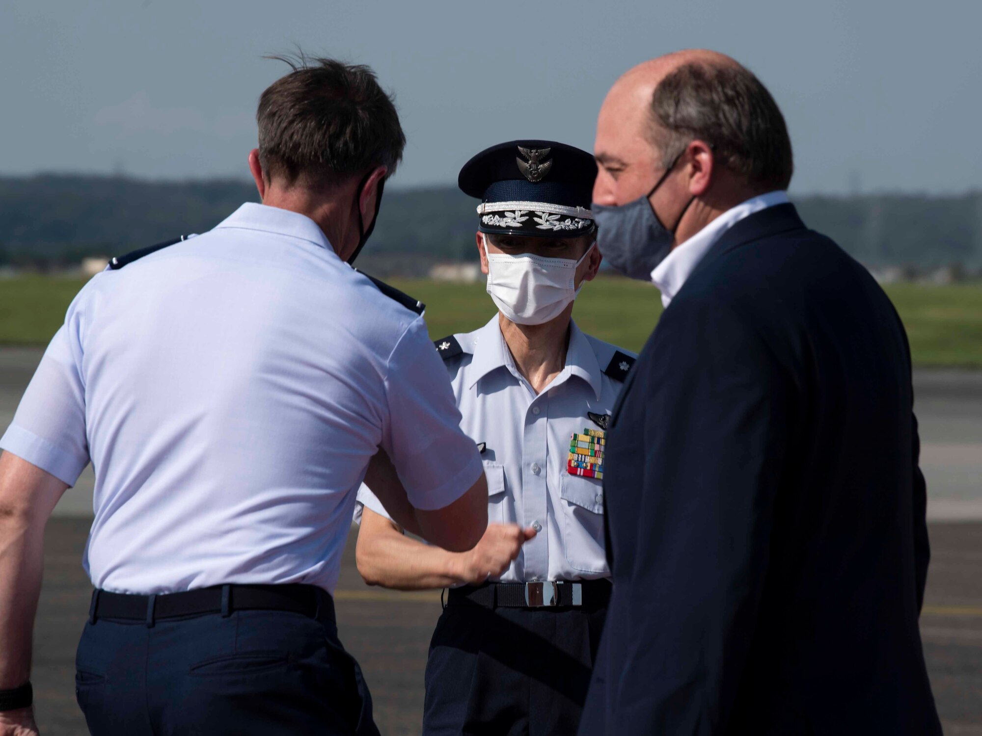 Lt. Gen. Kevin Schneider, left, U.S. Forces Japan and 5th Air Force commander, greets Japan Air Self-Defense Force Gen. Shuji Izutsu, center, chief of staff, and U.K. Secretary of State for Defence Ben Wallace, right, at Yokota Air Base, Japan, July 19, 2021.
