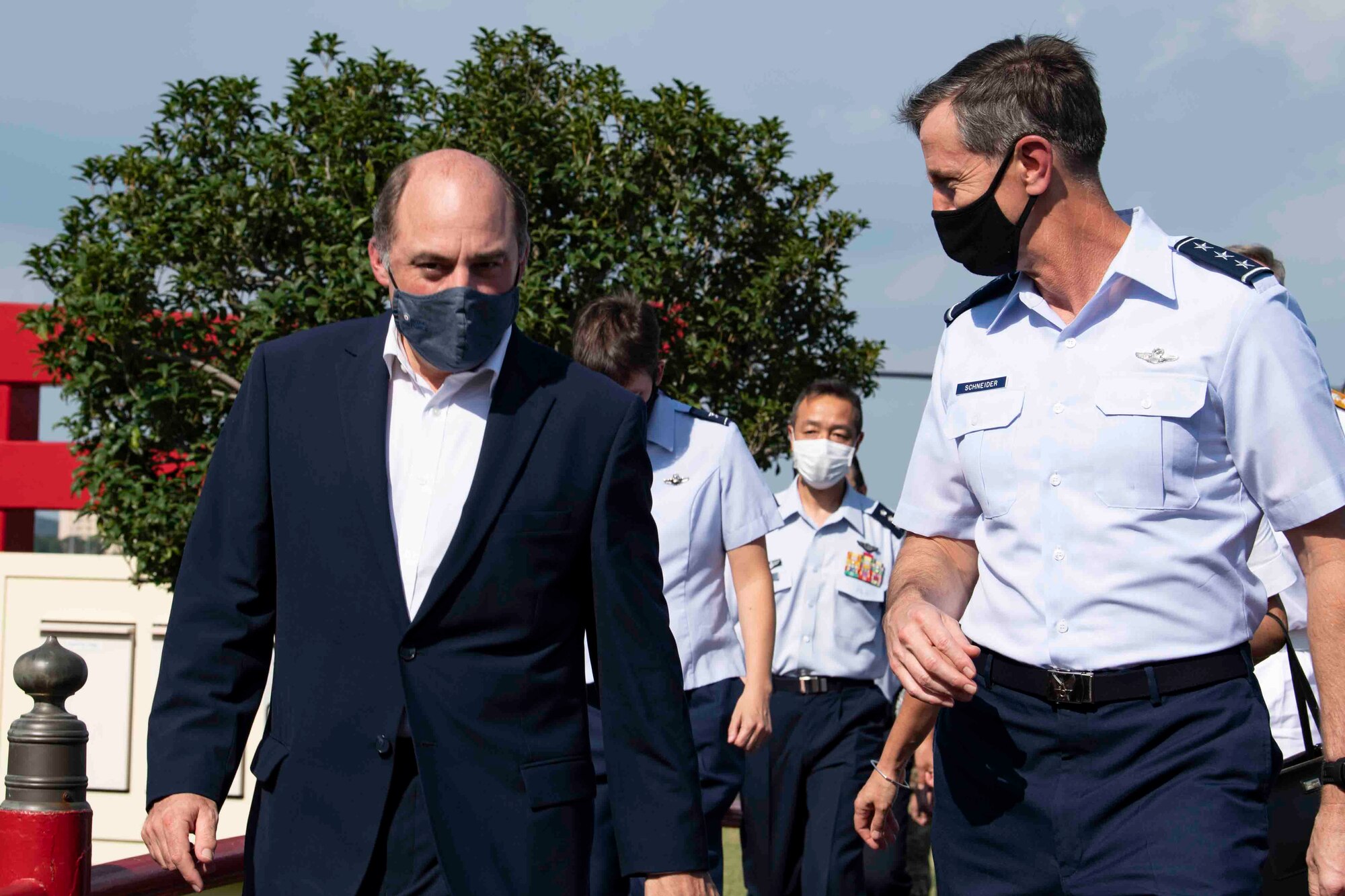 U.K. Secretary of State for Defence Ben Wallace and Lt. Gen. Kevin Schneider, U.S. Forces Japan and 5th Air Force commander, talk while leaving the flightline at Yokota Air Base, Japan, July 19, 2021.