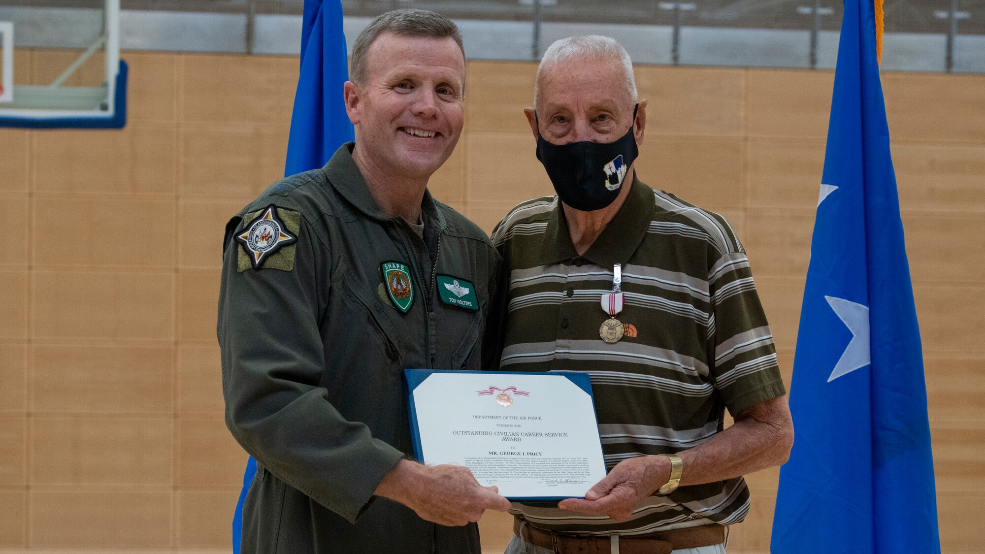 U.S. Air Force Gen. Tod Wolters, commander of U.S. European Command and NATO Supreme Allied Commander-Europe (left), presents George Price, 52nd Force Support Squadron special events coordinator, with an Outstanding Civilian Service Award, July 14, 2021, on Spangdahlem Air Base, Germany. The award is given to employees who demonstrate important accomplishments, leadership and significant impact upon the Air Force mission. (U.S. Air Force photo by Tech. Sgt. Anthony Plyler)