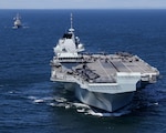 HMS Prince of Wales and HMS Queen Elizabeth pictured at sea for the first time with USS The Sullivans.