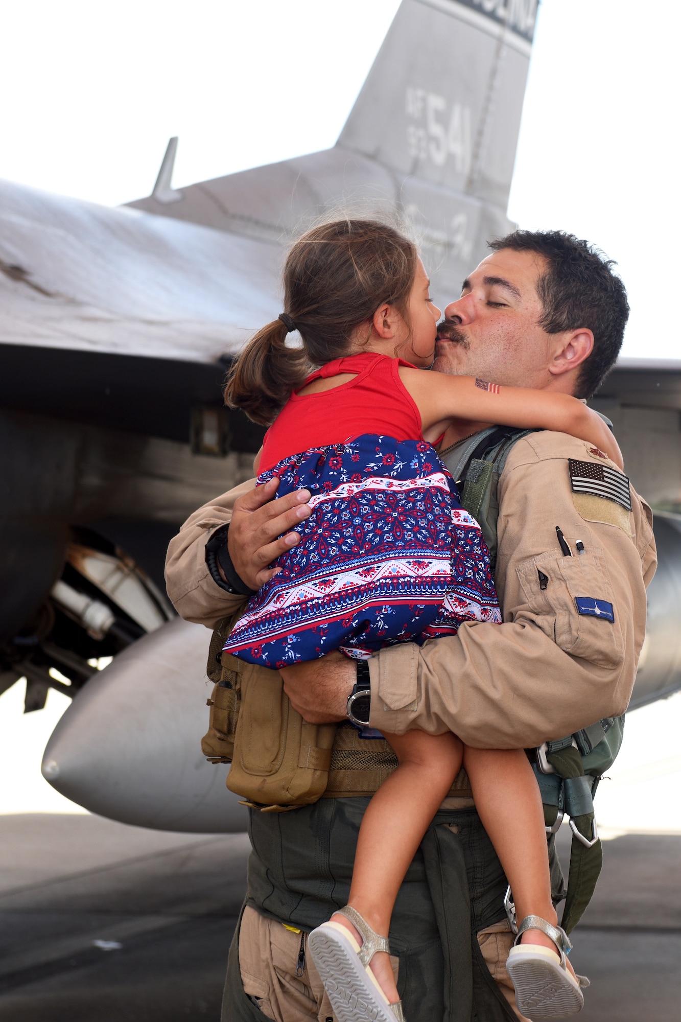 U.S. Air Force Maj. Joshua Rosecrans, a 157th Fighter Squadron pilot, greets his daughter at McEntire Joint National Guard Base, South Carolina, after returning from a deployment to Prince Sultan Air Base, Kingdom of Saudi Arabia, July 16, 2021. “Swamp Fox” Airmen from the South Carolina Air National Guard’s 169th Fighter Wing were deployed to PSAB for the past three months to project combat power and help bolster defensive capabilities against potential threats in the region. (U.S. Air National Guard photo by Senior Airman Mackenzie Bacalzo, 169th Fighter Wing Public Affairs)
