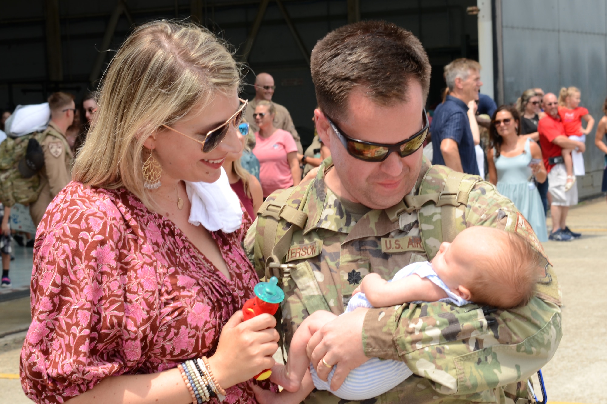 U.S. Air Force Lt. Col. Grady Patterson meets his new born son for the first time July 18, 2021 at McEntire Joint National Guard Base, South Carolina. U.S. Air Force personnel from the 169th Fighter Wing returned today after being deployed to Prince Sultan Air Base, Kingdom of Saudi Arabia for the past three months to project combat power and help bolster defensive capabilities against potential threats in the region. (U.S. Air National Guard photo by Lt. Col. Jim St.Clair, 169th Fighter Wing Public Affairs)