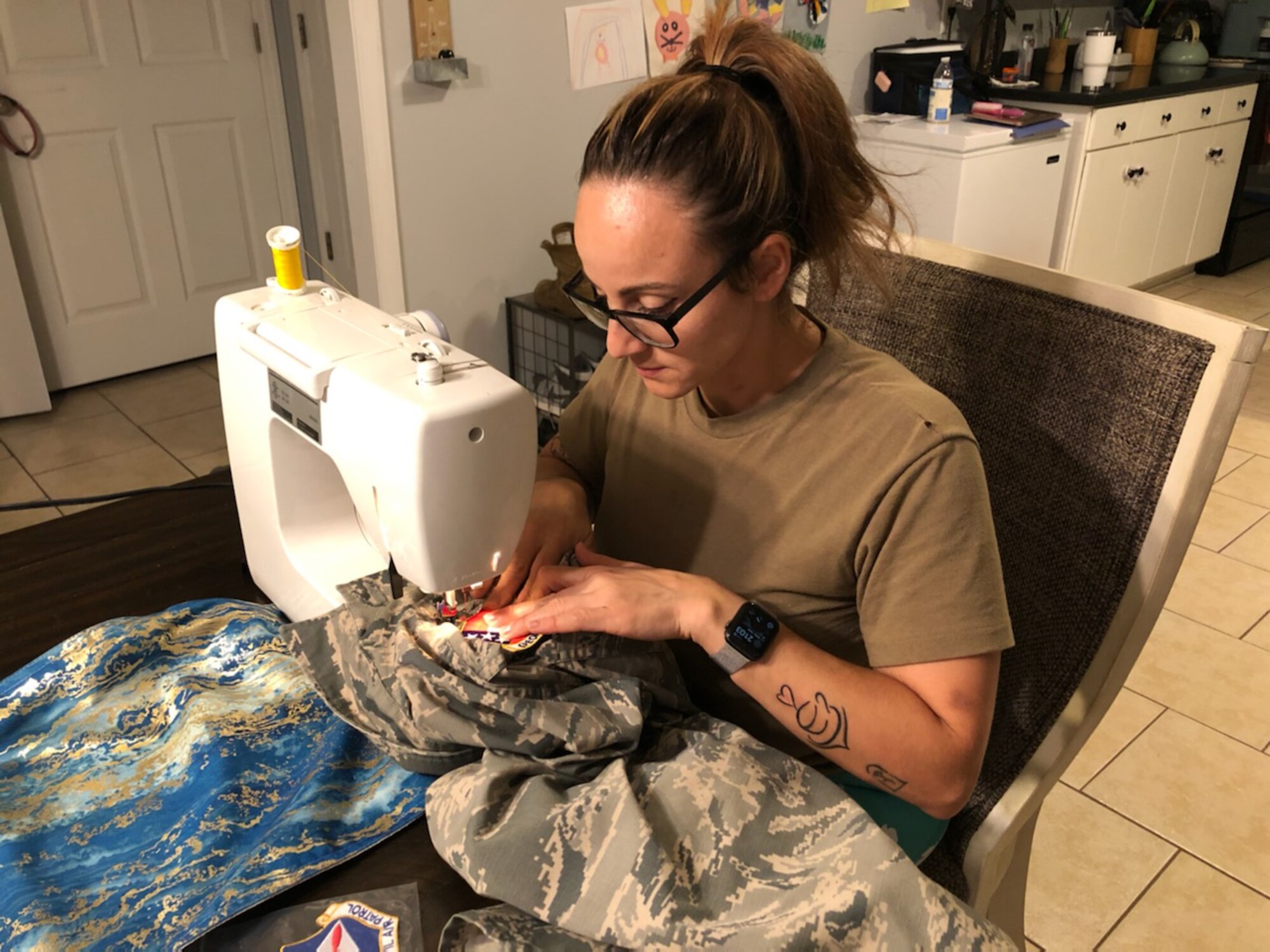 woman sewing uniforms
