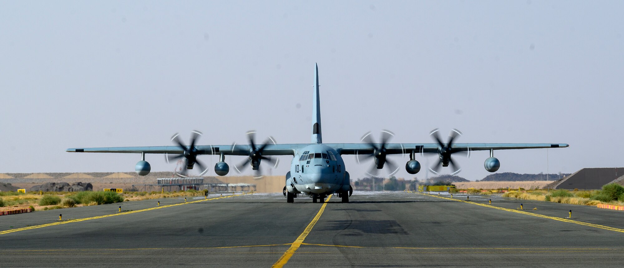 A U.S. Marine Corps KC-130J Hercules taxis upon arrival at a forward location for a “hot pit” aircraft-to-aircraft refueling of two U.S Air Force F-16 Fighting Falcons during a counter unmanned aerial system integration mission with joint and Royal Saudi aircraft, Kingdom of Saudi Arabia, June 30, 2021. U.S. Air Forces Central aircraft regularly work with coalition and partner nations to test their collective counter-UAS capabilities to ensure the security and stability of regional airspace. (U.S. Air Force photo by Senior Airman Samuel Earick)