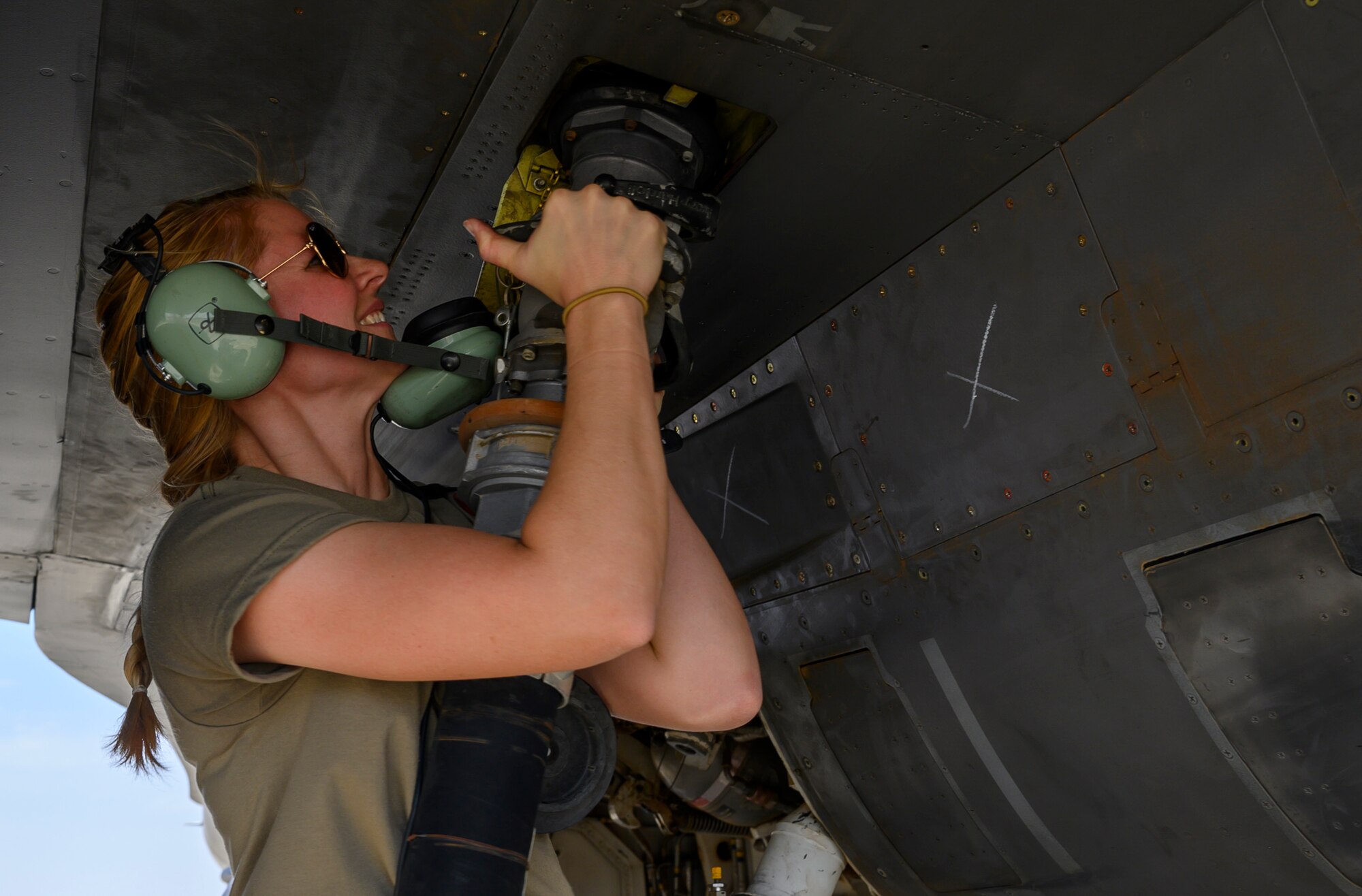 U.S. Air Force Staff Sgt. Rebecca Sumpter, 157th Expeditionary Fighter Generation Squadron weapons load crew, attaches the fuel hose to a U.S. Air Force Fighting Falcon F-16 during a counter unmanned aerial system integration mission with joint and Royal Saudi aircraft at a forward location in the Kingdom of Saudi Arabia, June 30, 2021. U.S. Air Forces Central aircraft regularly work with coalition and partner nations to test their collective counter-UAS capabilities to ensure the security and stability of regional airspace. (U.S. Air Force photo by Senior Airman Samuel Earick)