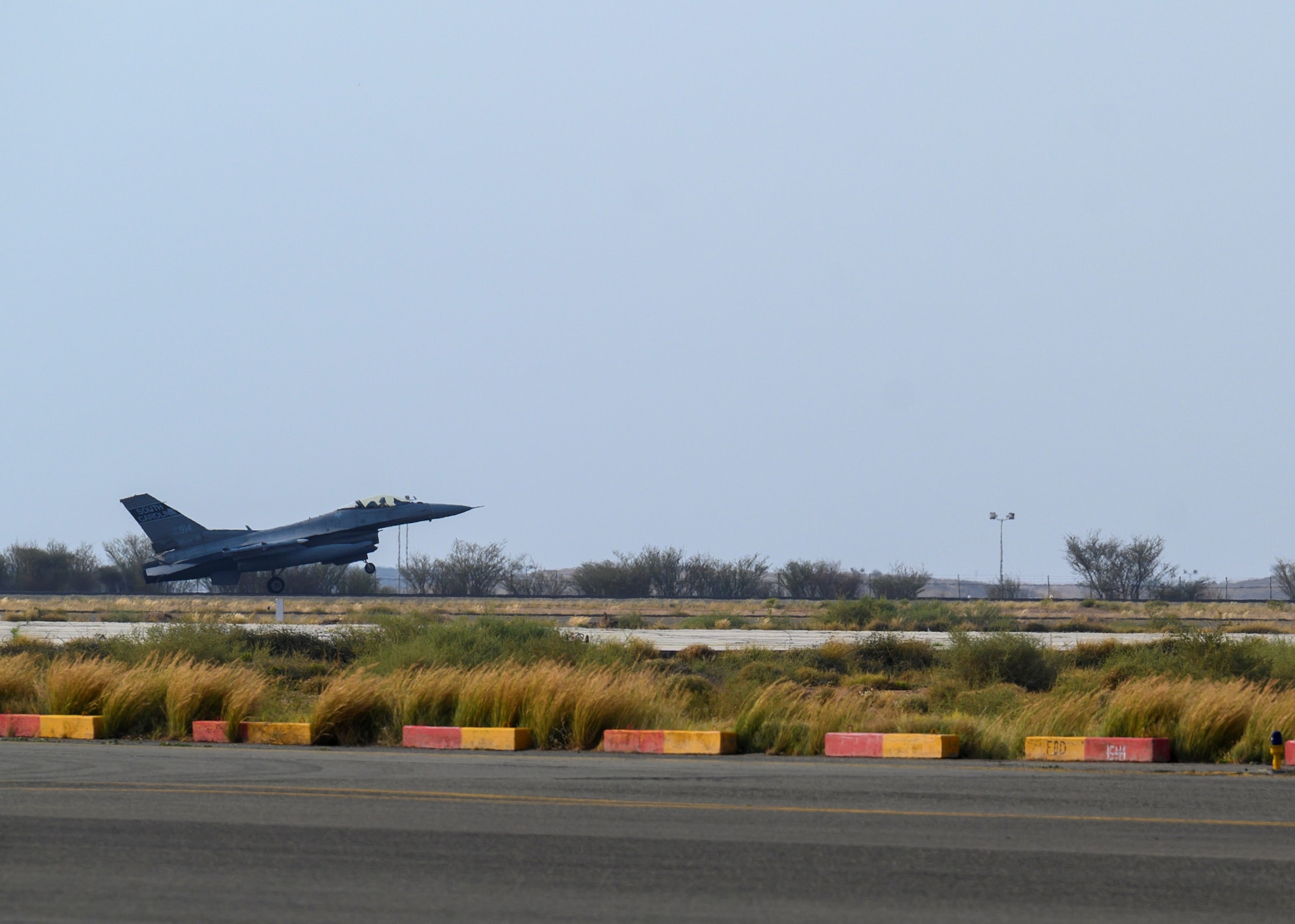 A U.S. Air Force F-16 Fighting Falcon arrives for a counter unmanned aerial system integration mission with joint and Royal Saudi aircraft at a forward location in the Kingdom of Saudi Arabia, June 30, 2021. U.S. Air Forces Central aircraft regularly work with coalition and partner nations to test their collective counter-UAS capabilities to ensure the security and stability of regional airspace. (U.S. Air Force photo by Senior Airman Samuel Earick)