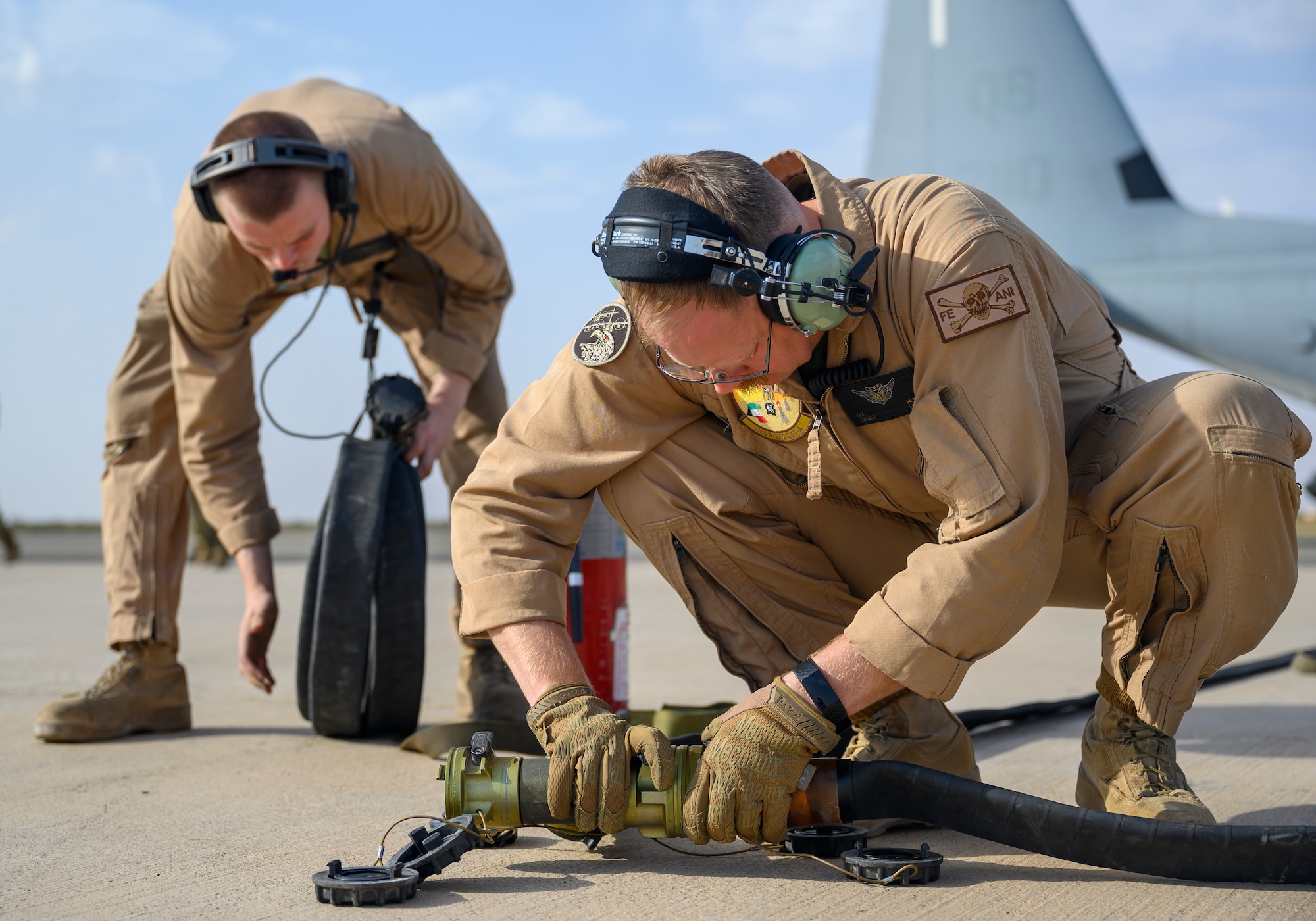 U.S. Marines with Marine Aerial Refueler Transport Squadron 352, assigned to Special Purpose Marine Air-Ground Task Force – Crisis Response – Central Command, connect a fuel hose for a “hot pit” aircraft-to-aircraft refueling during a counter unmanned aerial system integration mission with joint and Royal Saudi aircraft at a forward location in the Kingdom of Saudi Arabia, June 30, 2021. U.S. Air Forces Central aircraft regularly work with coalition and partner nations to test their collective counter-UAS capabilities to ensure the security and stability of regional airspace. (U.S. Air Force photo by Senior Airman Samuel Earick)