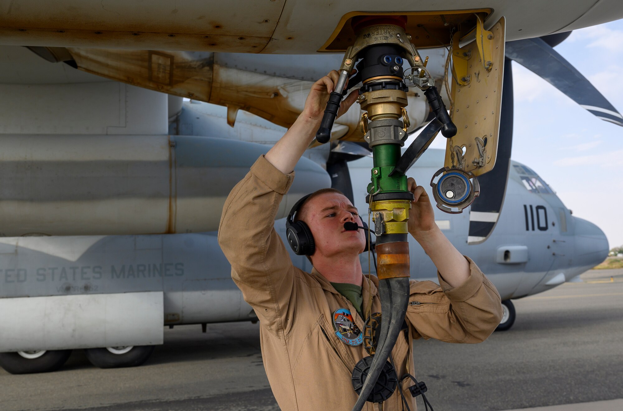 A U.S. Marine with Marine Aerial Refueler Transport Squadron 352, assigned to Special Purpose Marine Air-Ground Task Force – Crisis Response – Central Command, connects a fuel hose to a U.S. Marine Corps KC-130J Hercules during a counter unmanned aerial system integration mission with joint and Royal Saudi aircraft at a forward location in the Kingdom of Saudi Arabia, June 30, 2021. U.S. Air Forces Central aircraft regularly work with coalition and partner nations to test their collective counter-UAS capabilities to ensure the security and stability of regional airspace. (U.S. Air Force photo by Senior Airman Samuel Earick)