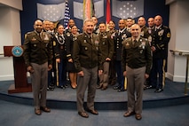 Group of men and women pose for a photo.