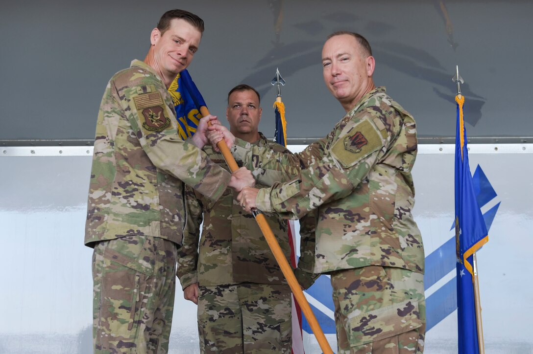 two men holding a flag and posing