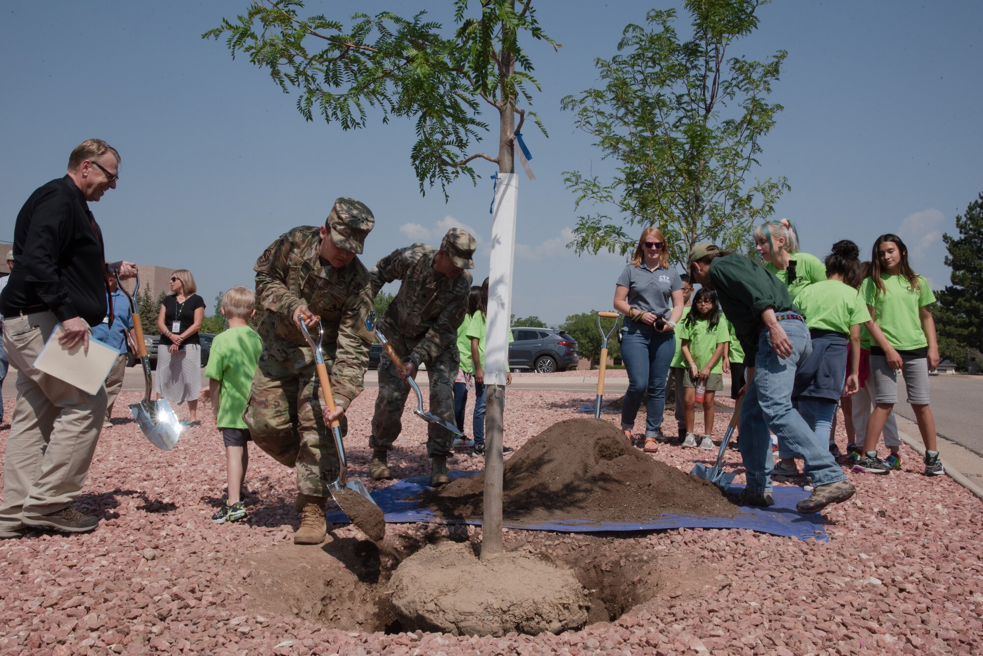U.S. Air Force Col. David Wilson, 21st Mission Support Group commander, left, and U.S. Air Force Lt. Col. Timothy Fryar, 21st Civil Engineer Squadron commander, help bury the first of two trees planted in the annual Arbor Day tree planting ceremony on Peterson Air Force Base, Colorado, July 15, 2021.  Arbor Day dates back to April 10, 1872, when an estimated 1 million trees were planted in the state of Nebraska with prizes offered to counties and individuals who properly planted the largest number of trees. (U.S. Space force photo by Airman Aaron Edwards)