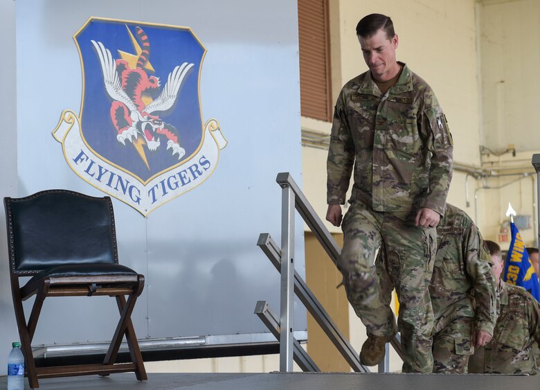 three men walking on a stage