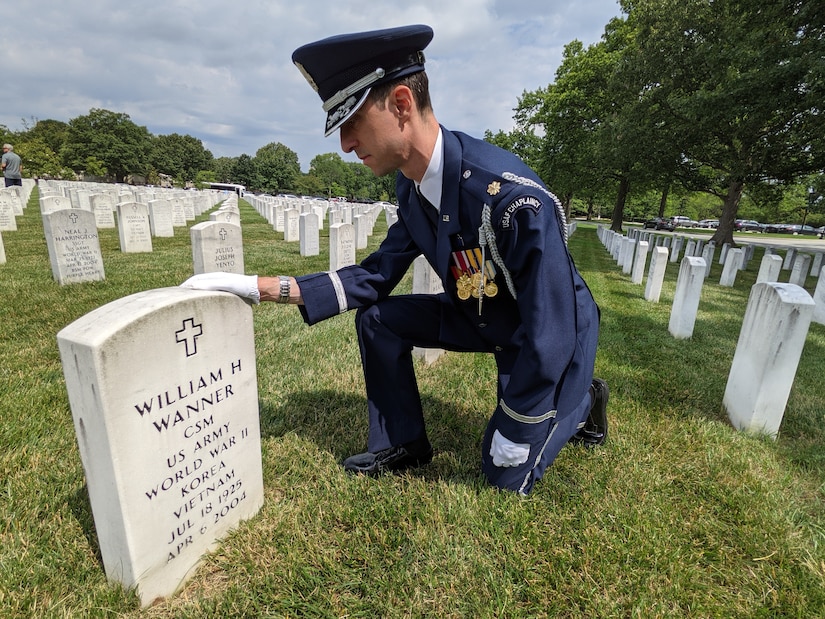 Maj. Steven Rein, Chaplain 11th Wing Operation Group, salutes the gravesite of a fallen Veteran at Arlington National Cemetery, Arlington, Virginia, June 11, 2021. The Arlington National Cemetery Chaplain Corps, under the 11th Wing Operation Group at Joint Base Anacostia-Bolling, serves at Arlington National Cemetery. The Chaplains provide religious rites and services for Air Force members and their families (U.S. Air Force photo by Brian Nestor)