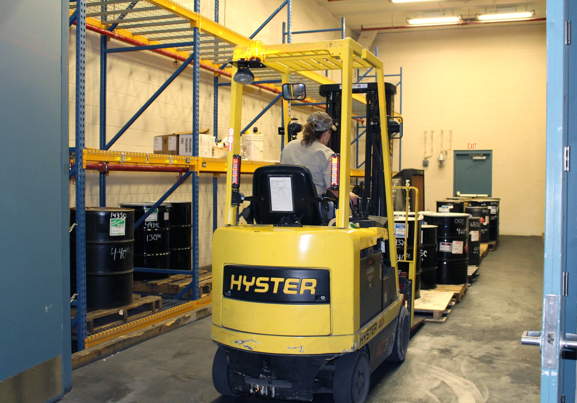 Annitta Evans, a logistics storekeeper, moves barrels of hazardous waste out of the storage facility at Arnold Air Force Base, Tenn., on June 15, 2021. The barrels are then loaded into the back of a tractor trailer and taken to a disposal facility offsite. (U.S. Air Force photo by Deidre Moon)