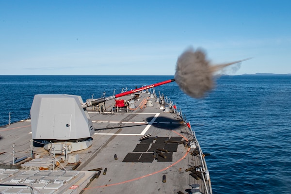The Arleigh Burke-class guided-missile destroyer USS Rafael Peralta (DDG 115) fires the 5-inch gun for Naval Surface Fire Support during Exercise Talisman Sabre 21.