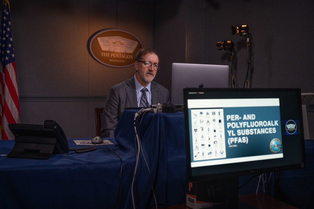 A man sits behind a laptop during an online presentation.