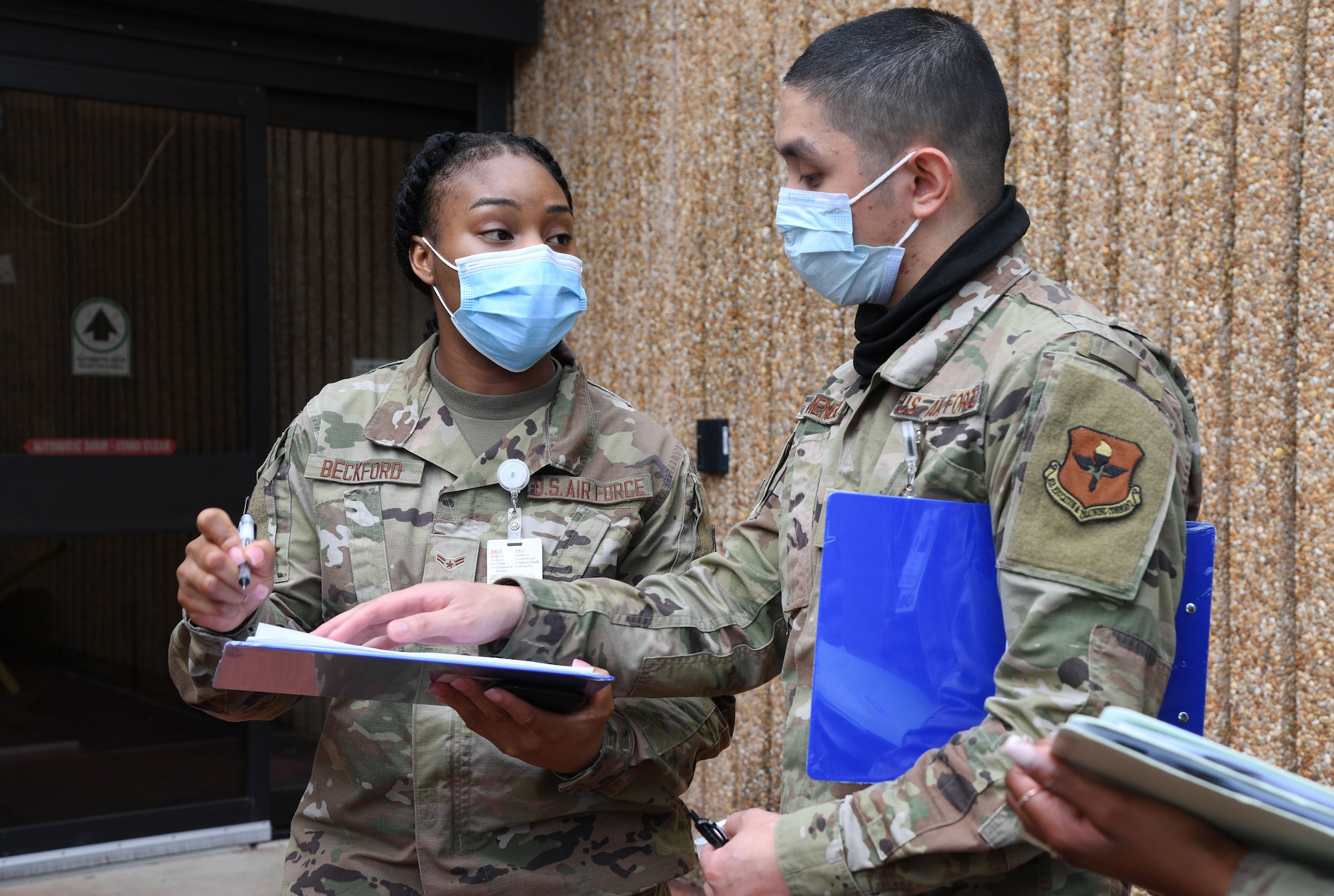 U.S. Air Force Airman 1st Class Brianna Beckford, 81st Medical Support Squadron outpatient records administrator, and Senior Airman Chrysdarius Meneses, 81st Diagnostic and Therapeutics Squadron radiology administrator, verify patient information during an 81st Medical Group functional exercise behind the Keesler Medical Center at Keesler Air Force Base, Mississippi, July 15, 2021. The scenario involved a chlorine cylinder explosion causing chemical burns and other injuries on several victims. The mass casualty exercise was held to prepare for real-world events by strengthening disaster medical response capabilities. (U.S. Air Force photo by Kemberly Groue)