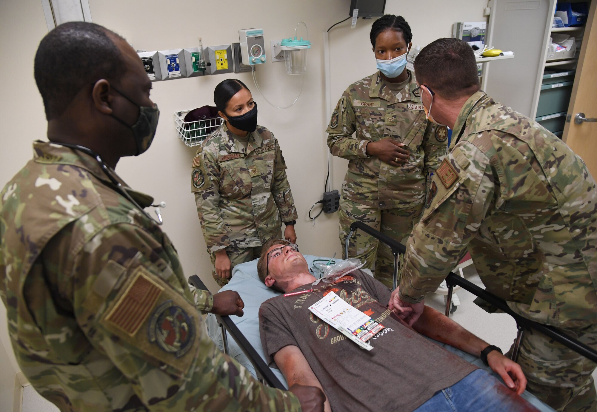 Members of the 81st Medical Group participate in an 81st MDG functional exercise behind the Keesler Medical Center at Keesler Air Force Base, Mississippi, July 15, 2021. The scenario included a chlorine cylinder explosion causing chemical burns and other injuries on several victims. The mass casualty exercise was held in preparation of real-world events by strengthening disaster medical response capabilities. (U.S. Air Force photo by Kemberly Groue)