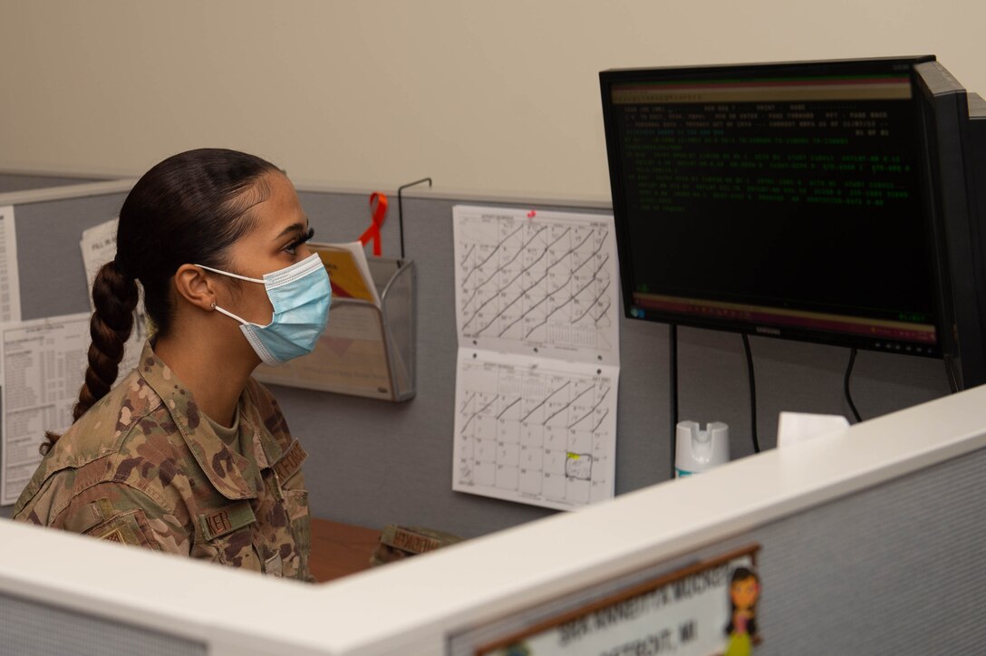 A photo of an Airman working on a desktop.