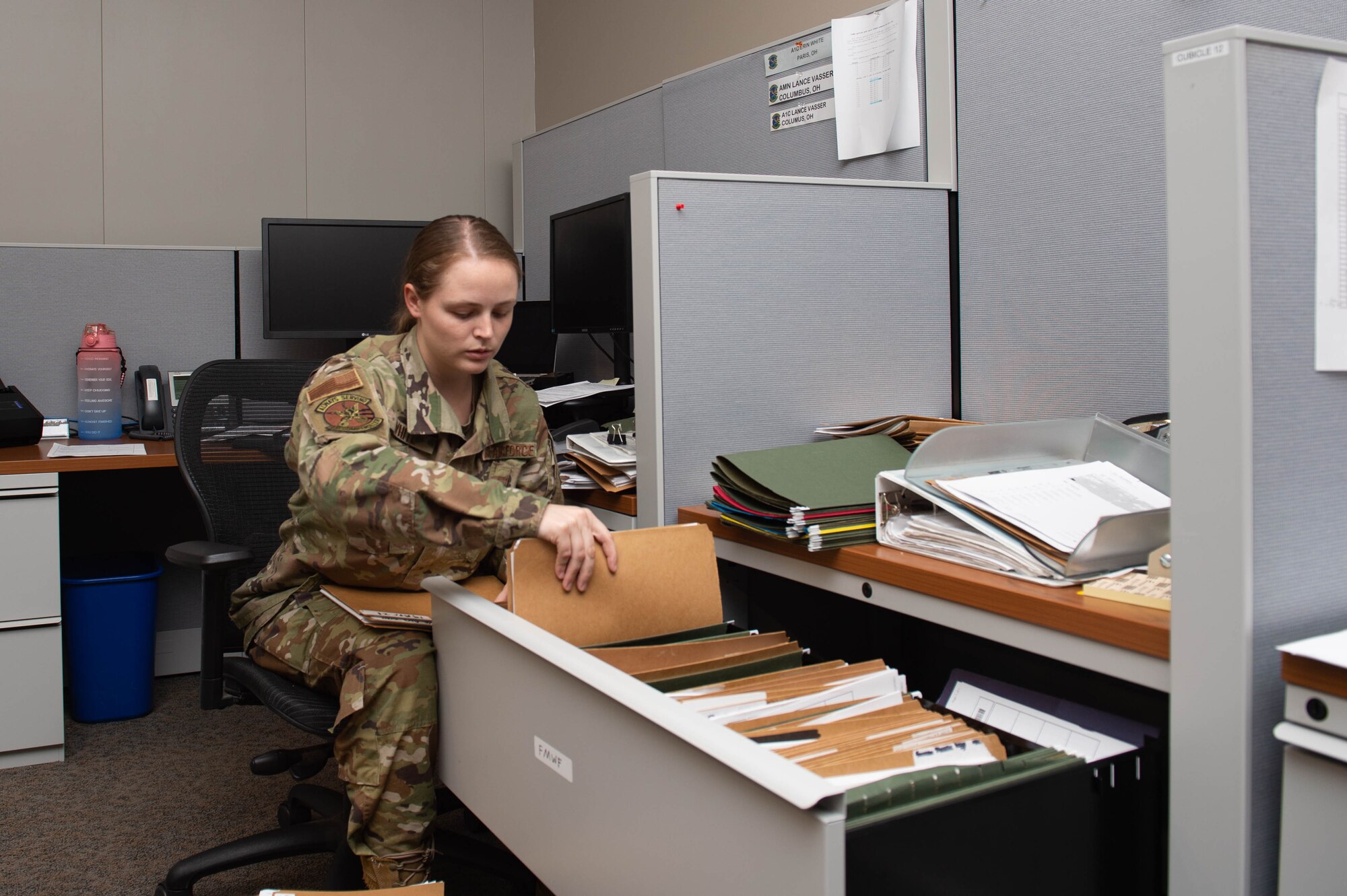 A photo of an Airman filing documents.