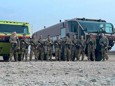 A quick reaction force, comprised of members of the 386th Expeditionary Civil Engineer Squadron, take a group photo at a forward operating base in Syria, May 22, 2021. The QRF are elite units, made up of Airmen from multiple squadrons trained in combat and evasion.