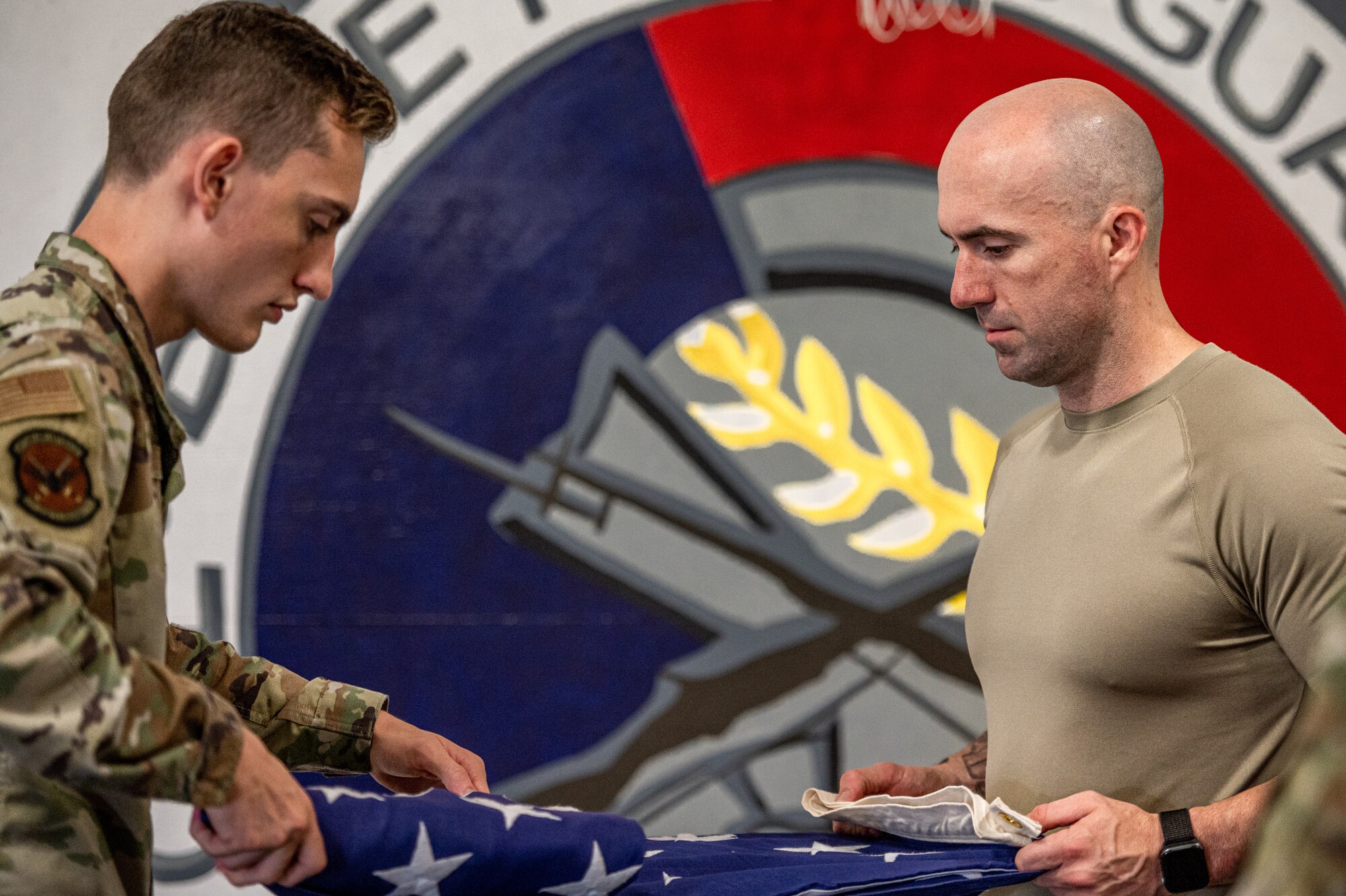 U.S. Air Force Airman 1st Class Christopher Wagner, 375th Logistics Readiness Squadron air transportation apprentice, and Master Sgt. Robert Van Buren, 113th Air Support Operations Squadron first sergeant, and folds a flag on Scott Air Force Base, Illinois, July 9, 2021. The ceremonial guardsmen will go back to their units with increased knowledge and train their wingmen on what they learned from USAF Honor Guard. (U.S. Air Force Photo by Airman 1st Class Isaac Olivera)