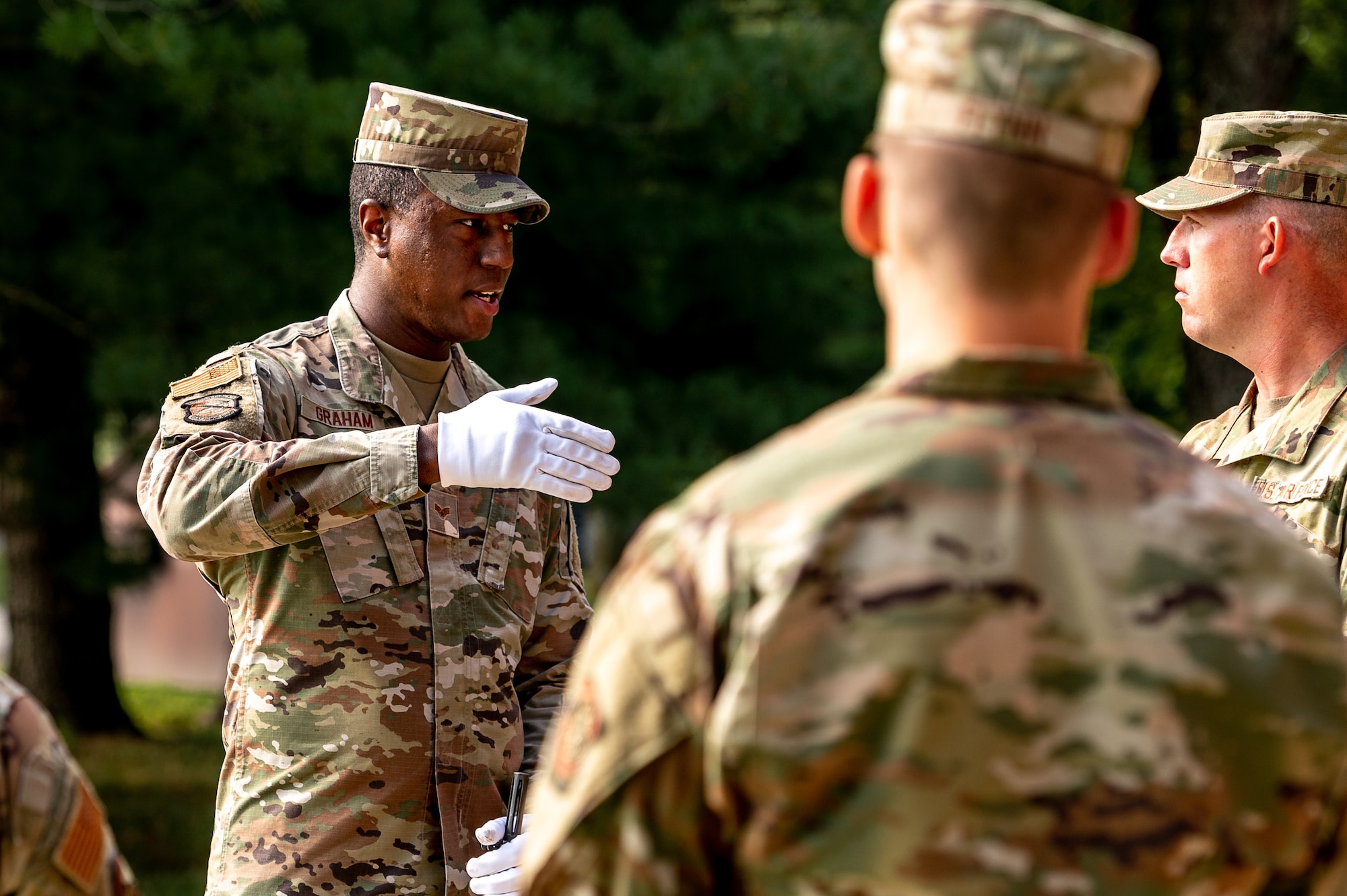 U.S. Air Force Senior Airman Jalen Graham, USAF Honor Guard ceremonial guardsman, instructs ceremonial guardsmen about drill movements on Scott Air Force Base, Illinois, July 9, 2021. Ceremonial guardsmen have to follow a strict code of conduct that they train in and follow for ceremonies. (U.S. Air Force Photo by Airman 1st Class Isaac Olivera)