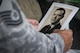 Airman holds old photo of .former commander.