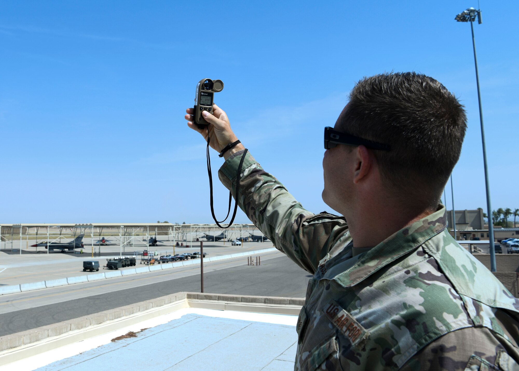 Staff Sgt. Craig Cassell, 56th Operations Support Squadron weather flight shift supervisor, measures the wind speed June 15, 2021, at Luke Air Force Base, Arizona.