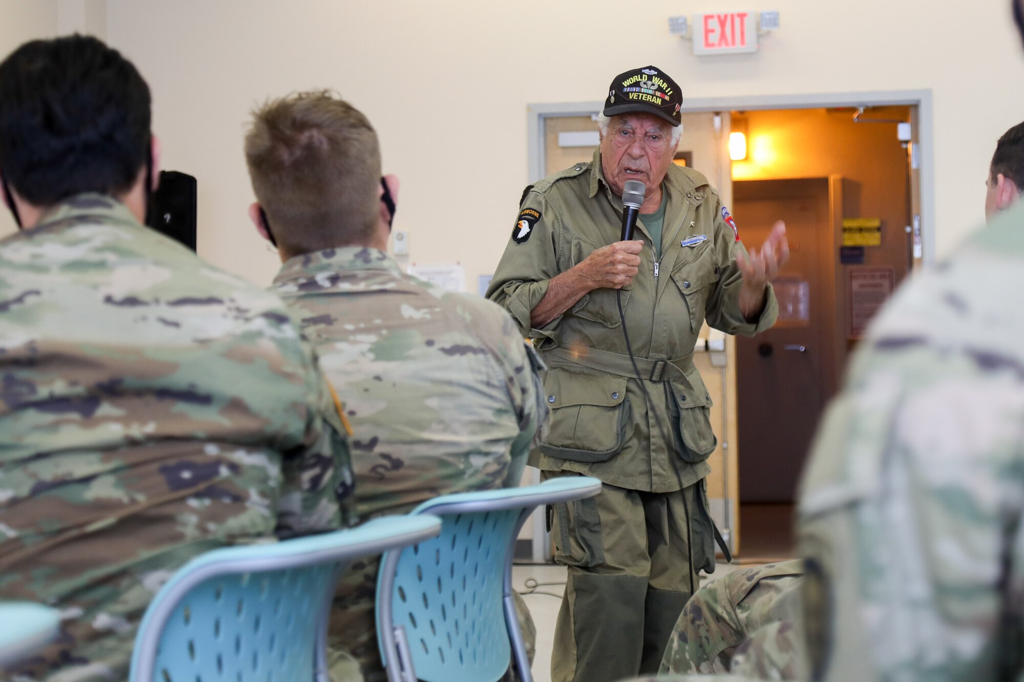 Vincent Speranza, World War II Veteran and machine gunner from the 501st Infantry Regiment, describes the extreme conditions he and his fellow paratroopers faced during the Battle of the Bulge to junior paratroopers of the 1st Battalion, 501st Infantry Regiment, during a visit to Joint Base Elmendorf-Richardson, July 15, 2021. Speranza traveled to JBER to meet and share stories about his World War II experiences with the paratroopers of the 1-501st PIR and the 4th Infantry Brigade Combat Team (Airborne), 25th Infantry Division, “Spartan Brigade.” The Spartan Brigade is the only airborne infantry brigade combat team in the Arctic and Pacific theaters, providing the combatant commander with the unique capability to project an expeditionary force by air.