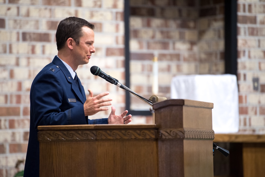 Photo of Airman speaking at podium