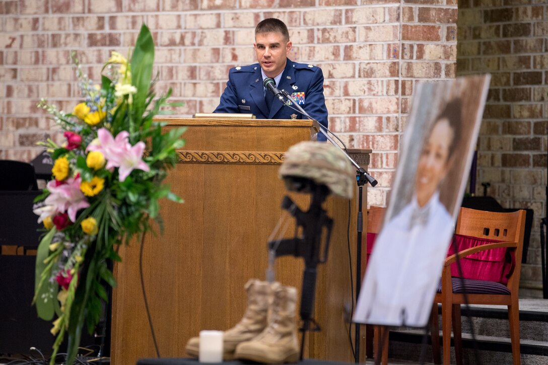 Photo of Airman talking at podium