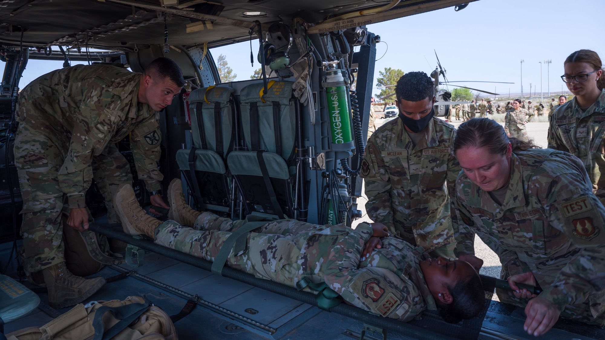 412th Medical Group load a patient onto a UH-60 Blackhawk helicoper during a training session at Edwards Air Force Base, California, July 15. Soldiers from C Company, "Desert Dustoff," 2916th Aviation Battalion, 916th Support Brigade, out of Fort Irwin, provided the training to the Edwards AFB Airmen. (Air Force photo by Giancarlo Casem)