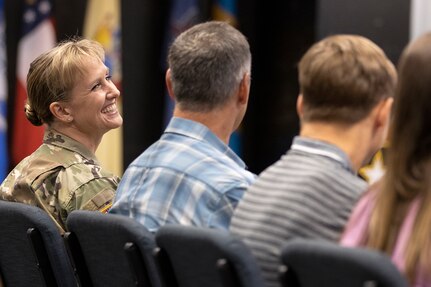 Col. Paige M. Jennings, U.S. Army Financial Management Command commander, is all smiles as she looks at her husband, Larry Jennings, during a ceremony at the Maj. Gen. Emmett J. Bean Federal Center in Indianapolis July 15, 2021. During his remarks, Gen. Edward M. Daly, U.S. Army Materiel Command commanding general, noted that the Jennings 28th wedding anniversary was two days after the assumption of command ceremony. (U.S. Army photo by Mark R. W. Orders-Woempner)