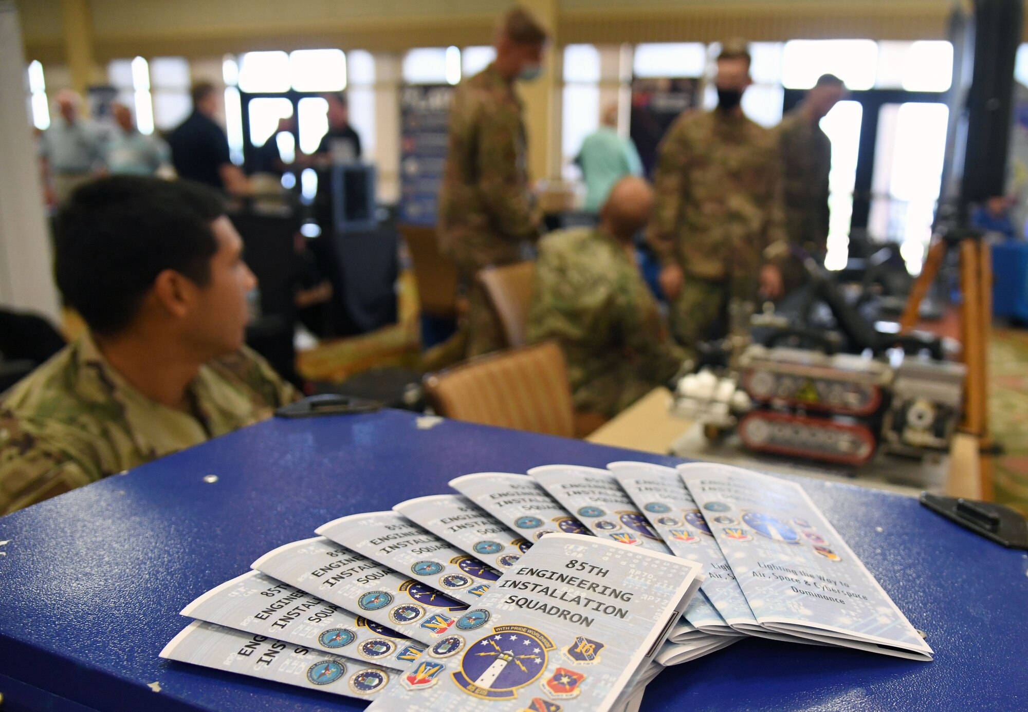 Pamphlets highlighting 85th Engineering Installation Squadron mission capabilities are displayed during the Technology Expo inside the Bay Breeze Event Center at Keesler Air Force Base, Mississippi, July 15, 2021. The expo, hosted by the 81st Communications Squadron and the Armed Forces Communications and Electronics Association Gulf Coast Chapter, was held to introduce military members to the latest in technological advancements to bolster the Air Force's capabilities in national defense. (U.S. Air Force photo by Kemberly Groue)