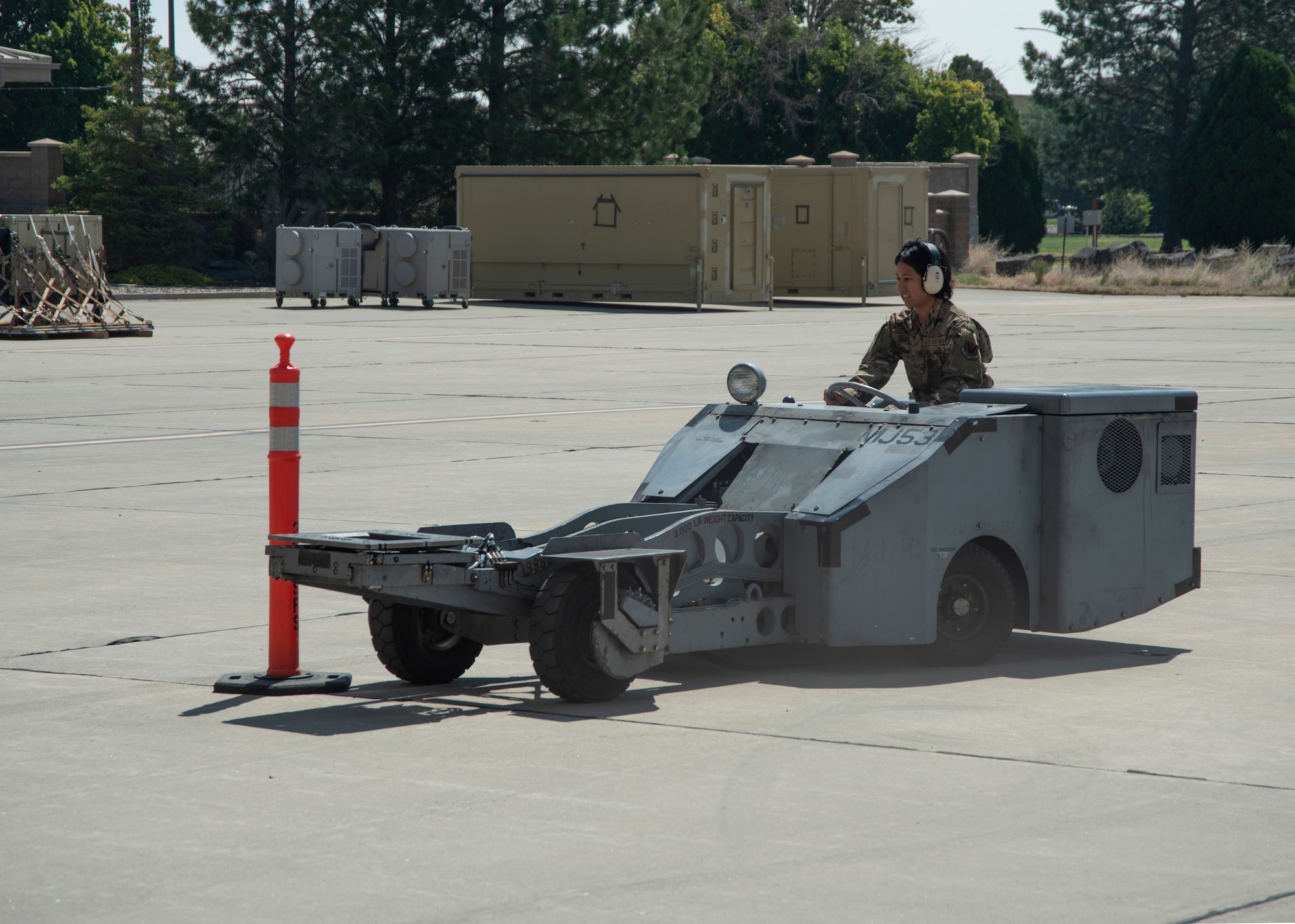 An Airman drives a jammer vehicle between cones.