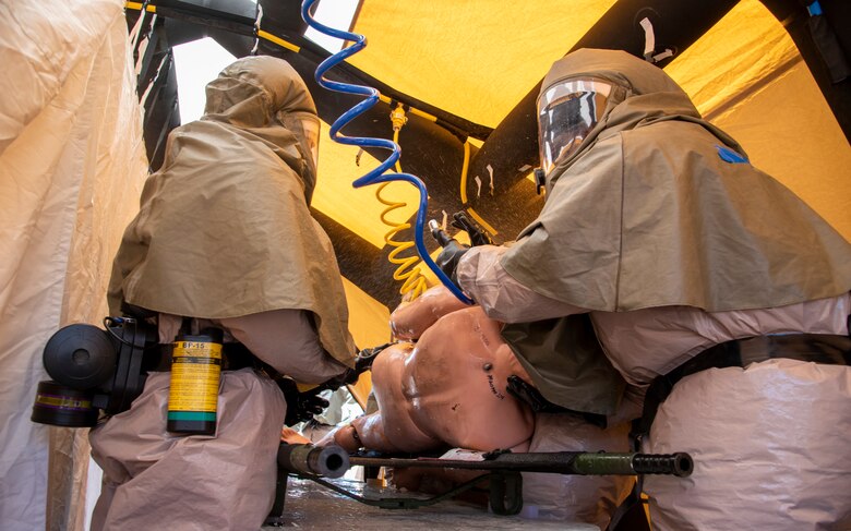 Airmen decontaminate patient during exercise