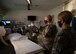 Second Lt. Charmagne Verano, 99th Surgical Operations Squadron clinical nurse, briefs Lt. Gen. Robert Miller, U.S. Air Force and U.S. Space Force surgeon general, and Chief Master Sgt. Dawn Kolczynski, U.S. Air Force and U.S. Space Force chief medical enlisted force