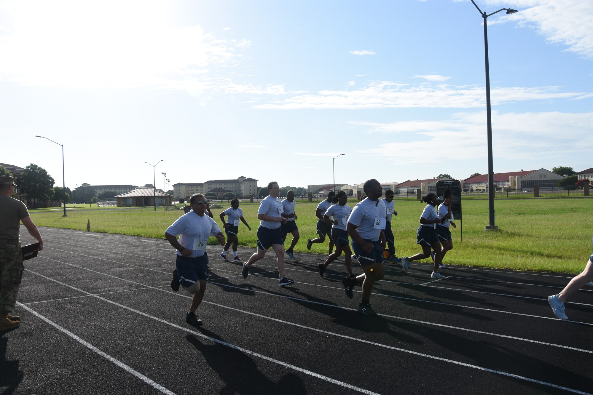 People run on a track early morning.