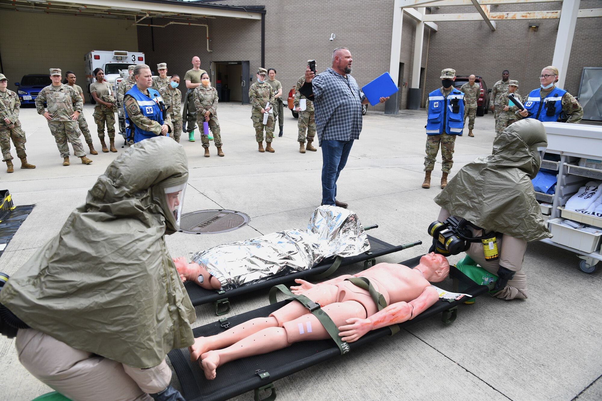 Members of the 81st Medical Group participate in an 81st MDG functional exercise behind the Keesler Medical Center at Keesler Air Force Base, Mississippi, July 15, 2021. The scenario involved a chlorine cylinder explosion causing chemical burns and other injuries on several victims. The mass casualty exercise was held to prepare for real-world events by strengthening disaster medical response capabilities. (U.S. Air Force photo by Kemberly Groue)