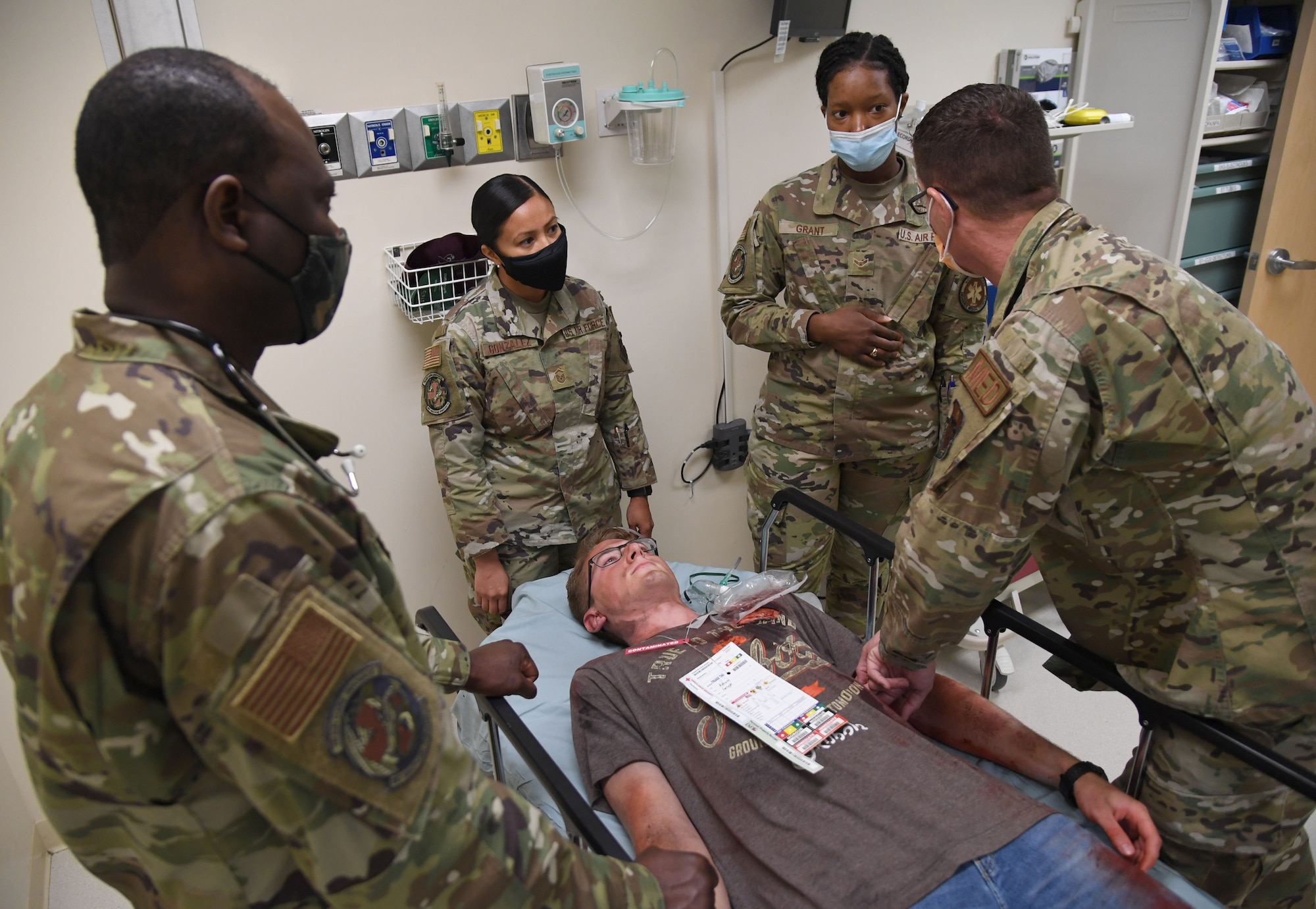 Members of the 81st Medical Group participate in an 81st MDG functional exercise behind the Keesler Medical Center at Keesler Air Force Base, Mississippi, July 15, 2021. The scenario included a chlorine cylinder explosion causing chemical burns and other injuries on several victims. The mass casualty exercise was held in preparation of real-world events by strengthening disaster medical response capabilities. (U.S. Air Force photo by Kemberly Groue)