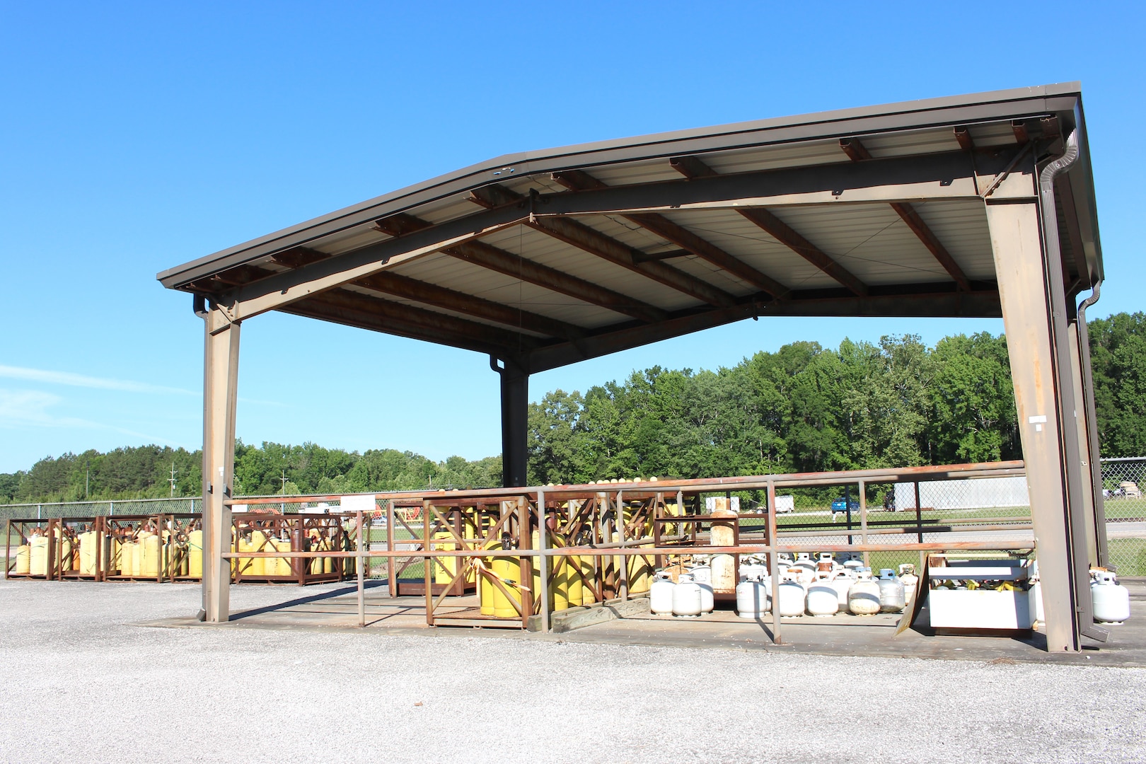 Hazardous materials are stored under a metal canopy at the HAZMART Pharmacy, pictured here June 15, 2021, at Arnold AFB, Tenn. The HAZMART Pharmacy distributes these materials and products to the shops requesting them. The facility is used by the Hazardous Waste and Hazardous Materials Program at Arnold to provide cradle-to-grave management of hazardous waste. (U.S. Air Force photo by Deidre Moon)