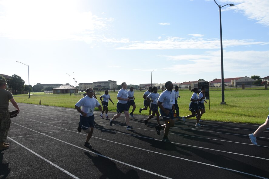 People run on a track early morning.