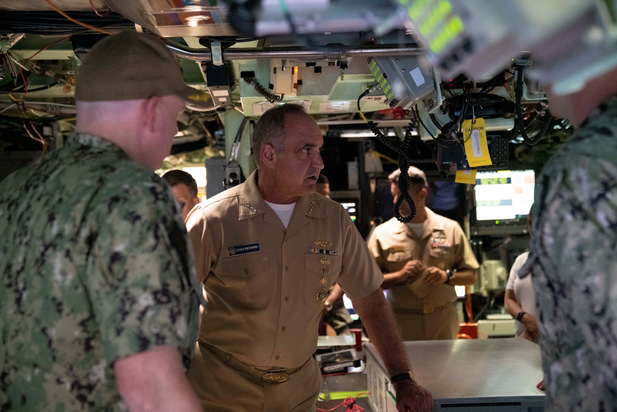 Admiral Chas Richard, Commander, United States Strategic Command, receives a brief in the control room of the Virginia-class fast-attack submarine USS Illinois (SSN 786). Richard visited commands on Guam to see how they fit into the USSTRATCOM mission of deterring strategic attack and employing forces, as directed, to guarantee the security of the nation and its allies.