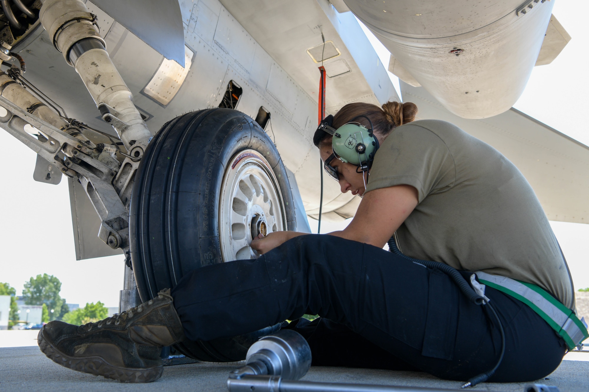 Senior Airman Brooke Parks, 555th Aircraft Maintenance Unit F-16 Fighting Falcon crew chief, changes a tire on a U.S. Air Force F-16 during exercise Thracian Star 21 at Graf Ignatievo Air Base, Bulgaria, July 9, 2021. As a crew chief, Parks services, inspects, refuels, changes tires, and performs heavy maintenance on F-16s. (U.S. Air Force photo by Airman 1st Class Brooke Moeder)