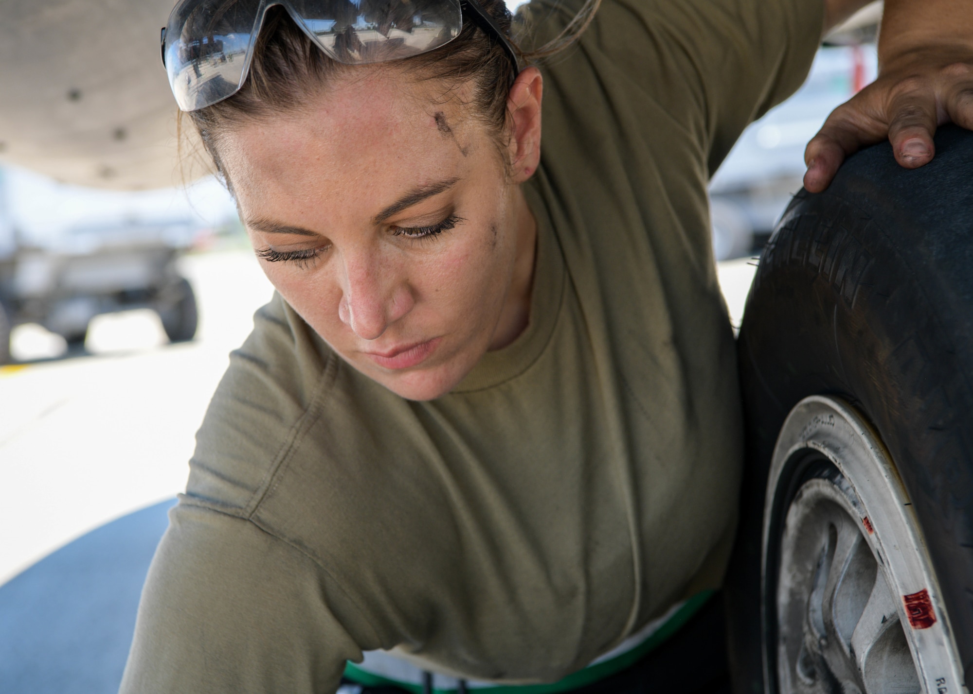 Senior Airman Brooke Parks, 555th Aircraft Maintenance Unit F-16 Fighting Falcon crew chief, replaces a tire on a U.S. Air Force F-16 Fighting Falcon at Graf Ignatievo Air Base, Bulgaria, July 9, 2021. Duties of a crew chief include overseeing daily maintenance, identifying malfunctions and replacing parts, conducting inspections and maintaining records, and coordinating aircraft care. (U.S. Air Force photo by Airman 1st Class Brooke Moeder)